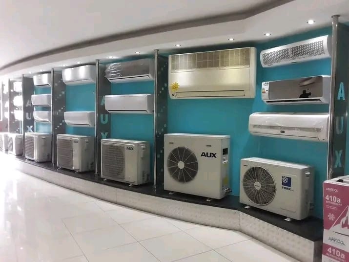 Professional AC technician working on unit